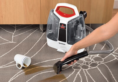 Aspiradora para quitar manchas Bissell Spot Clean sobre alfombra