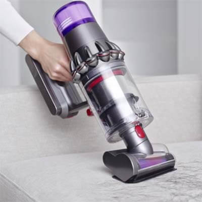 Dyson V15 Detect vacuuming a sofa