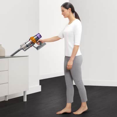 Dyson V15 Detect cleaning a piece of furniture