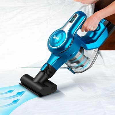 Inse S6 vacuuming a bed with the mini brush