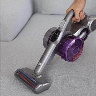 Vacuuming a sofa
