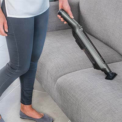 Vacuuming a sofa